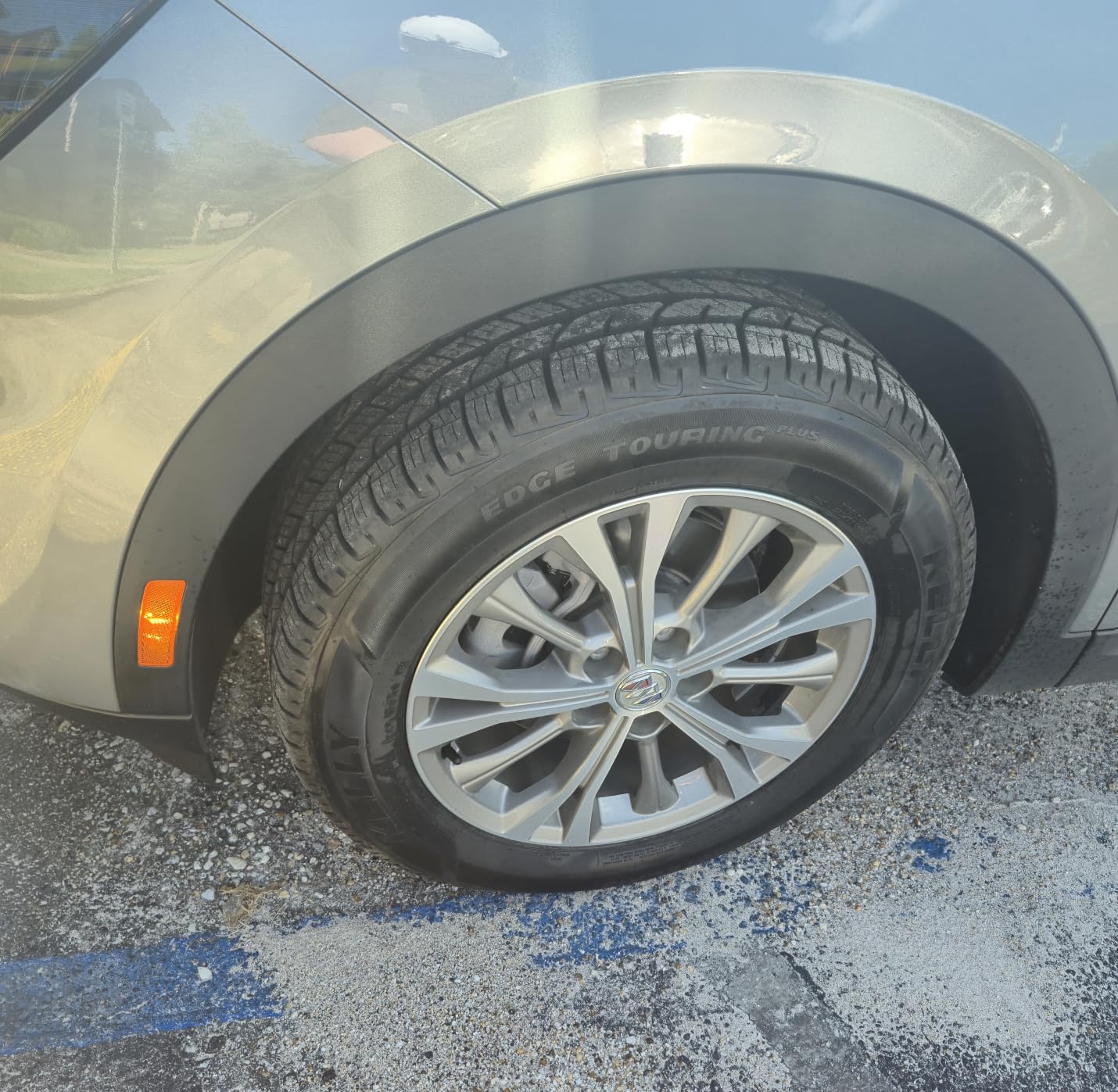 Kelly Edge Touring Plus mounted on a silver Cadillac sedan, photographed on wet asphalt